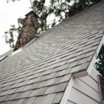 Roofing Emergencies - A picture of a sloped residential roof with asphalt shingles.